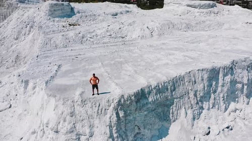Professional bodybuilder posing outdoors. Concept of beautiful healthy body. Aerial view