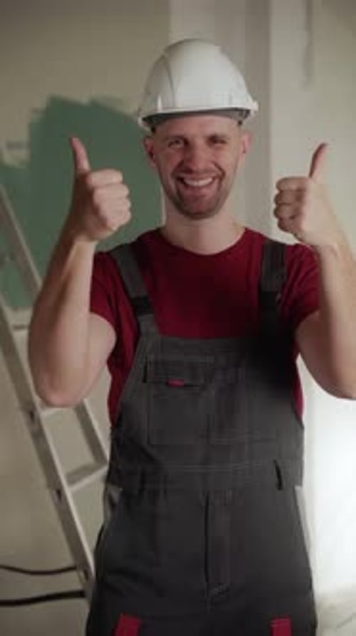 Smiling Builder Gesturing Thumbs Up During Home Renovation Project