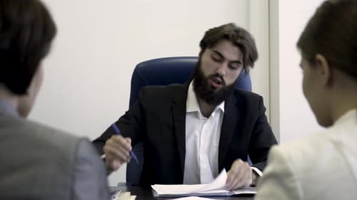 Man in Suit Arguing at Office Meeting