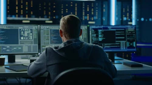 Man Coding in Dark Server Room Raises Fists