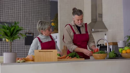 Seniors Preparing Healthy Food in Kitchen