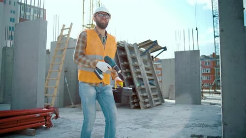 Construction Worker Walks On Urban Building Site