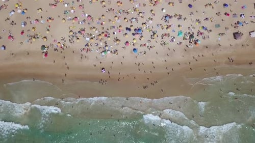 Summertime in a public Beach with colorful umbrellas
