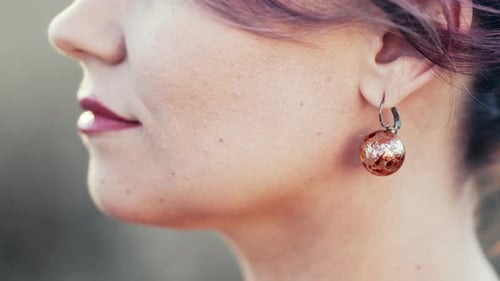 Elegant Woman with Round Earring Close-up