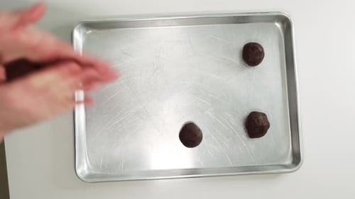 Rolling Cookie Dough Into Balls. Preparing Cookies On Baking Tray. overhead shot