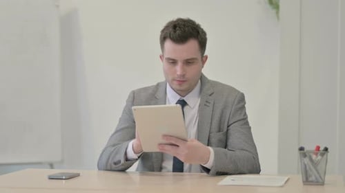 Young Adult Working on Tablet in Office Setting