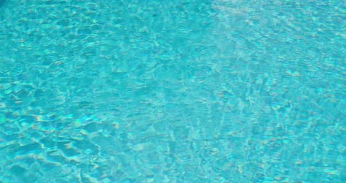 Turquoise Surface of the Pool Water with Small Waves