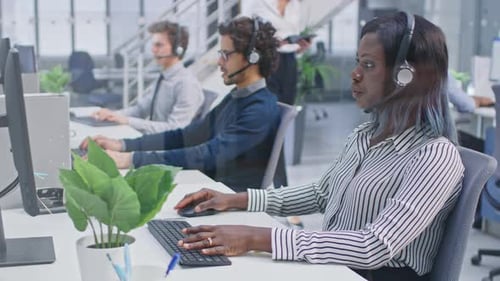 Call Center Agents Working at Computers in Office