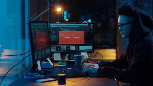 Cybercrime, Hacking and Technology Concept - Asian Male Hacker in Glasses Writing
