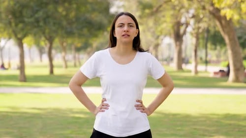 Woman Taking Deep Breaths in the Park