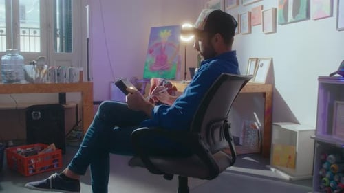 Creative Illustrator Using Stylus and Drawing on Digital Tablet in Art Studio