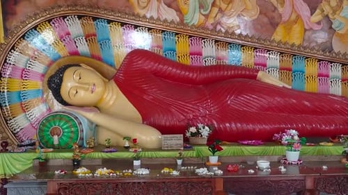 Reclining Buddha Statue with Colorful Backdrop
