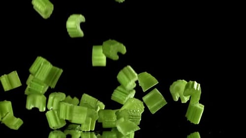 Sliced Pieces of Fresh Celery Fall on the Table Filmed on a Highspeed Camera at 1000 Fps