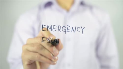 Hand Writes Emergency Escape Plan on Glass