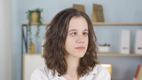 Woman Crossing Eyes and Smiling Indoors