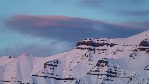 Timelapse of colorful sunset on the snowy mountain peaks in Utah