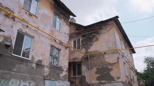 Dilapidated Building with Peeling Paint and Weathered Walls
