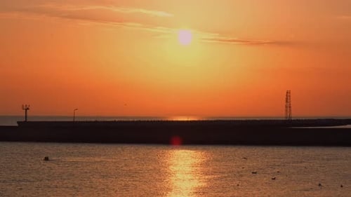 Reflection of Sunlight Over Sea Surface at Sunset