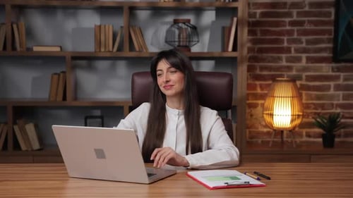 Caucasian Business Woman Closes Laptop and Feels Satisfied After Finishing Work in Her Office
