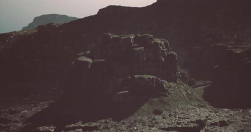 Rocky Landscape View at Dusk with Shadows and Rugged Terrain