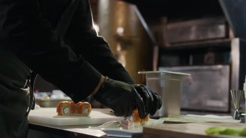 Male Chef Prepares Sushi in a Restaurant
