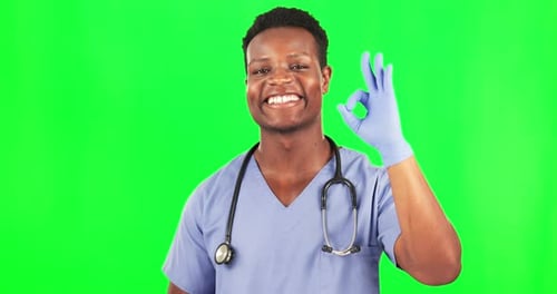 Black man, doctor and okay gesture on green screen, health with positive opinion