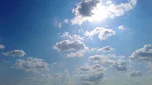 Clouds Drifting in a Blue Sky with Sun