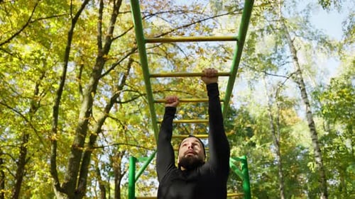 Caucasian Man Doing Pullups on the Bar