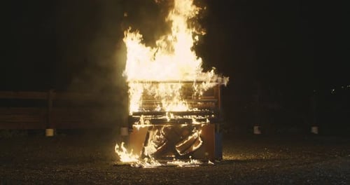 Burning Piano Ablaze at Night