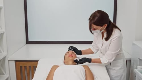 Woman Receiving Cosmetic Facial Procedure at Clinic