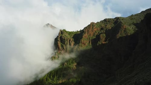 Aerial Flight to Fog Clouds Above Green Mountain Tops with Natural Sunshine