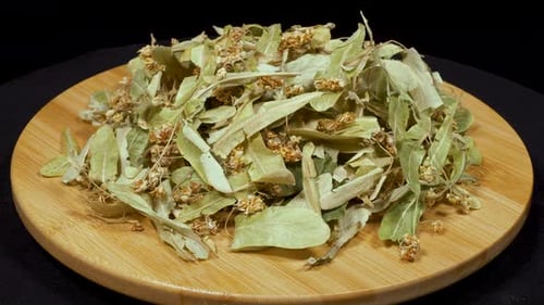 Dried Linden Flowers on Wooden Plate