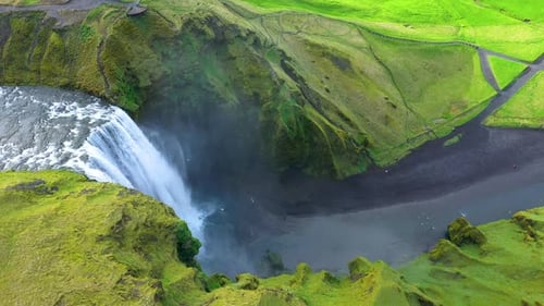 Aerial view of the Skogafoss waterfall, Iceland, flying above with a drone