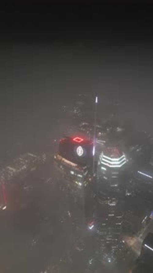 Aerial video of Los Angeles skyline at night in fog, California, USA