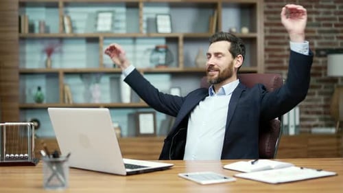 Bearded Man Working on Laptop at Desk