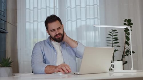 Adult Man Working At Home With Neck Pain