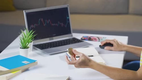 Adult Trading Bitcoin at Home Using Laptop