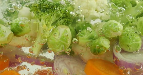 Vegetable mix for making soup in boiling water with air bubbles.