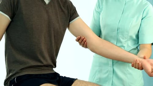 Man Receiving Arm Rehabilitation Therapy from Healthcare Worker