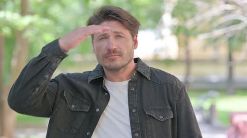 Man Shields Eyes in Park and Calls Out