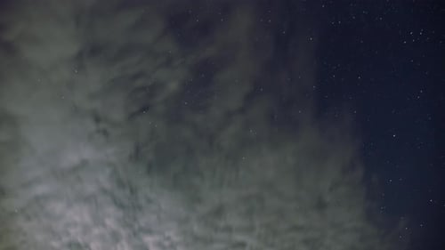 Starry Night Sky with Approaching Clouds