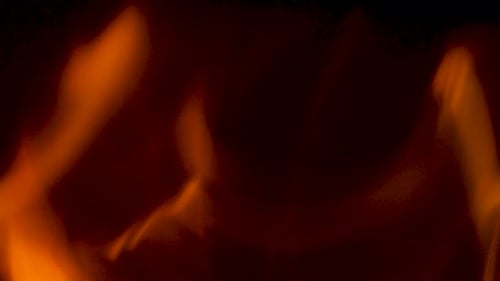 Close Up of Orange Flames Flickering on Black