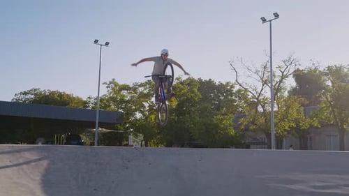 Young Adult Bike Stunt in Skatepark on Sunny Day