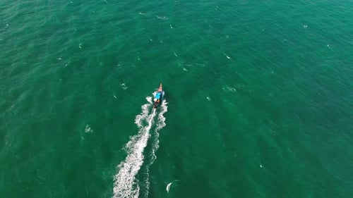 Longtail Boat Exploring The Breathtaking Blue Seascape Of Thailand