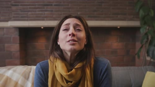 Sad young woman looking at the camera indoors