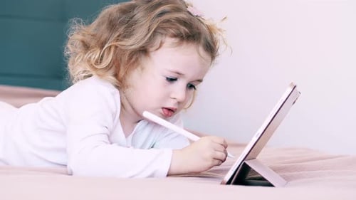 Young Child Drawing on Tablet with Stylus