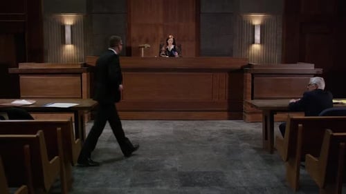 Lawyer approaching the bench - tilt up to reveal court room HD