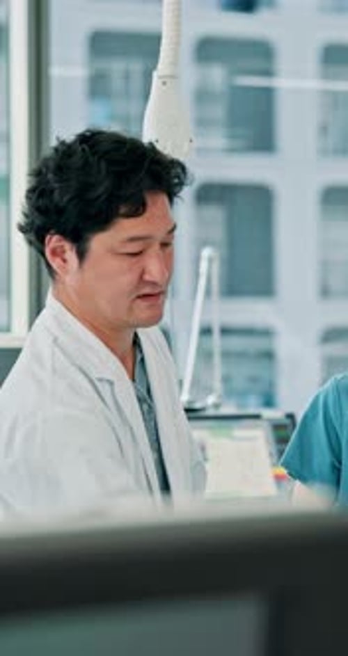 Doctor Talks With Colleague in Modern Hospital