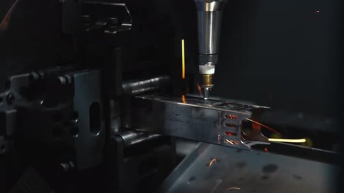 CNC Laser Cutting Machine With Sparks Processing Metal Sheet In Industrial Factory