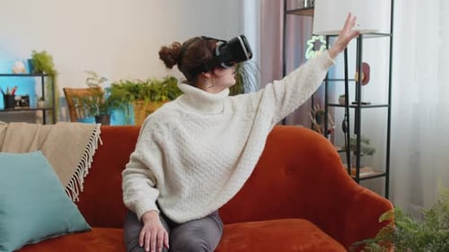 Woman Experiencing Virtual Reality Headset on Sofa